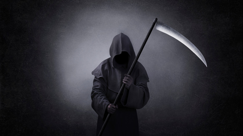 a grim reaper holding scythe