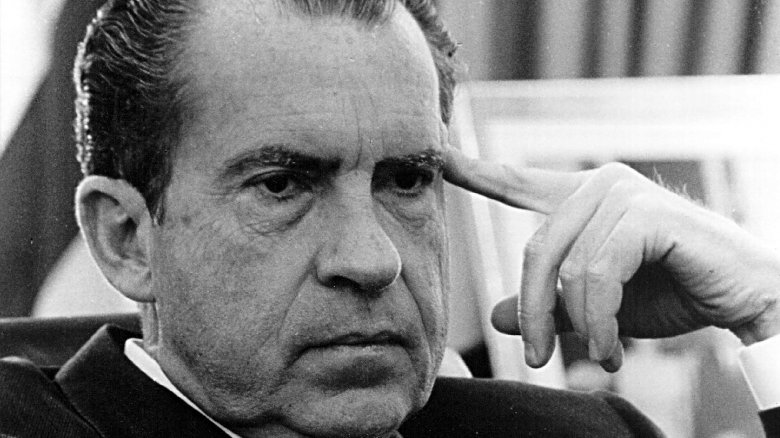 Richard Nixon finger on head