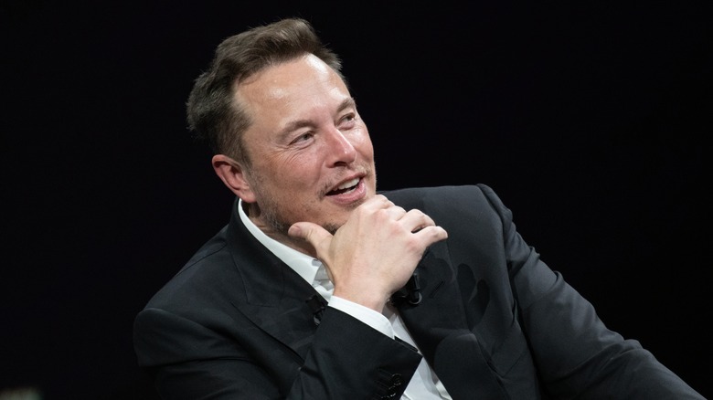 Elon Musk with hand on chin