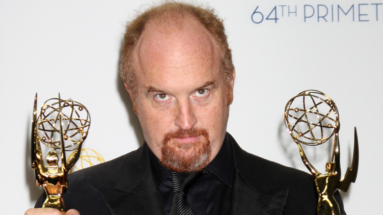 Louis C.K. holding two Emmys