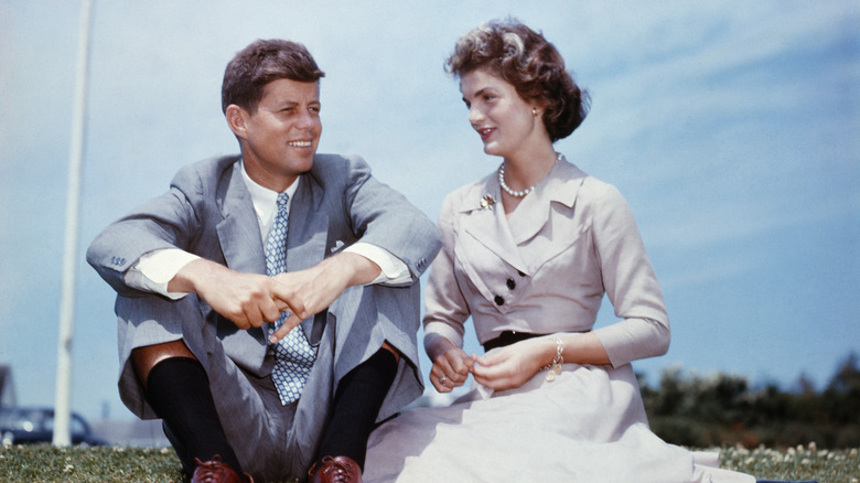 jackie and john f. kennedy sit together outside