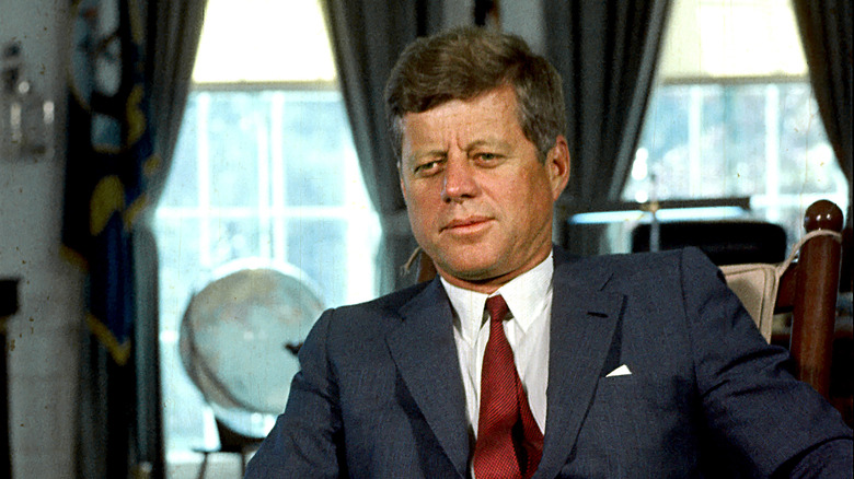 JFK sitting in oval office red tie