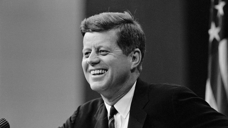 JFK smiling suit flag