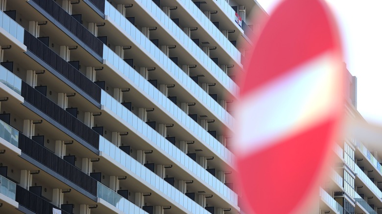 Tokyo Olympic Village with "do not enter" sign in foreground