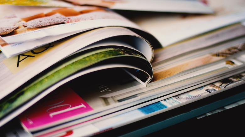 stack of magazines with pages open