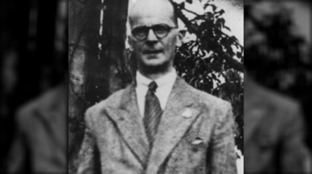 John Christie wearing suit and tie