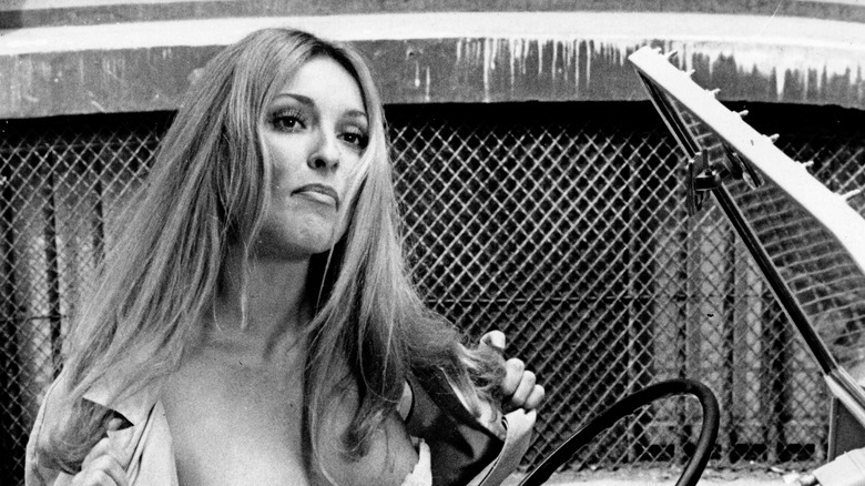 Sharon Tate holding jacket open in "The Thirteen Chairs"