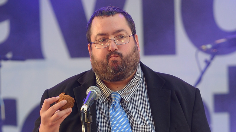 Ewen MacIntosh glasses standing mic, eating