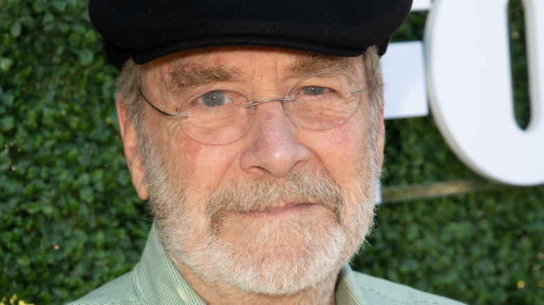 Martin Mull glasses black flatcap beard smiling