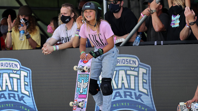 Sky Brown standing with skateboard