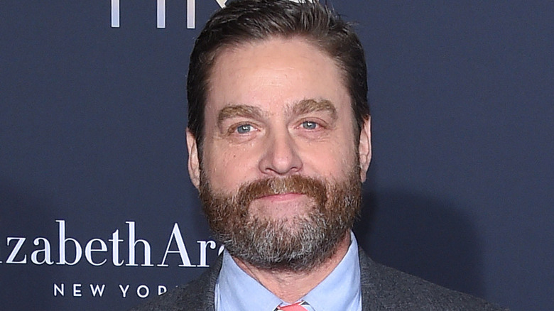 zach galifianakis smirking in suit