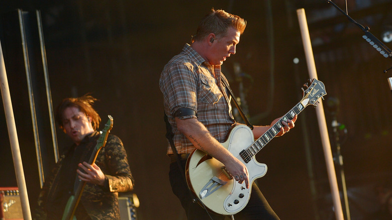 Josh Homme playing guitar