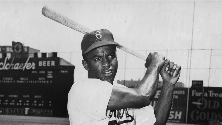 Jackie Robinson swinging a bat in 1949