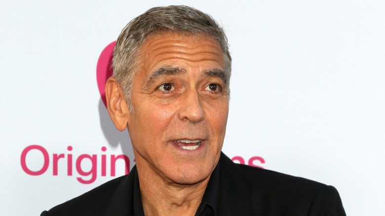 George Clooney smiling white background at event