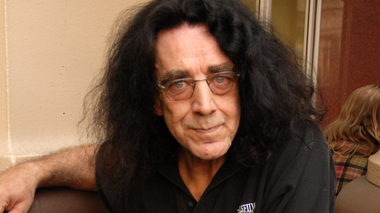 peter mayhew glasses long dark hair staring