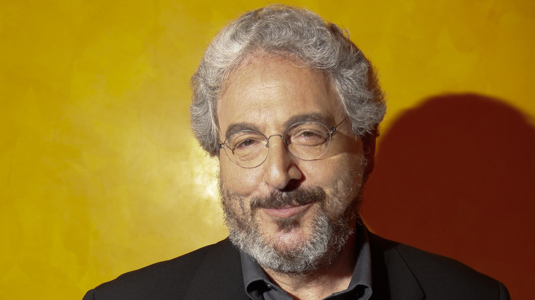 Harold Ramis posing orange background