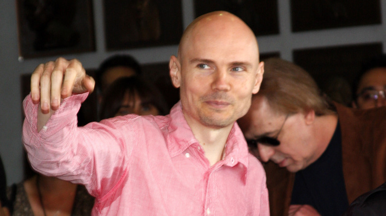 Billy Corgan pink shirt arm raised