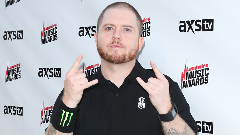 Jamey Jasta flashing horns at event