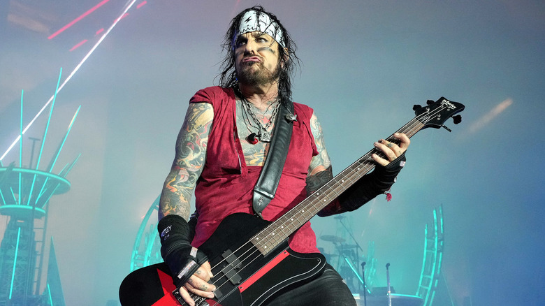 Nikki Sixx bandanna playing bass on stage