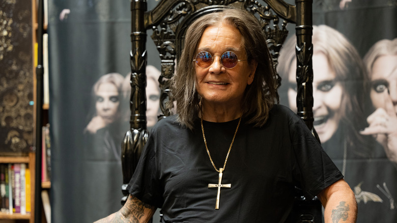 Ozzy Osbourne sunglasses sat smiling