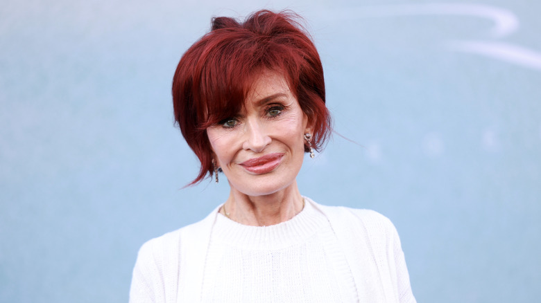 Sharon Osbourne white top red hair smiling