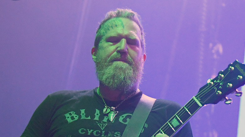 brent hinds mastodon playing onstage eyes closed