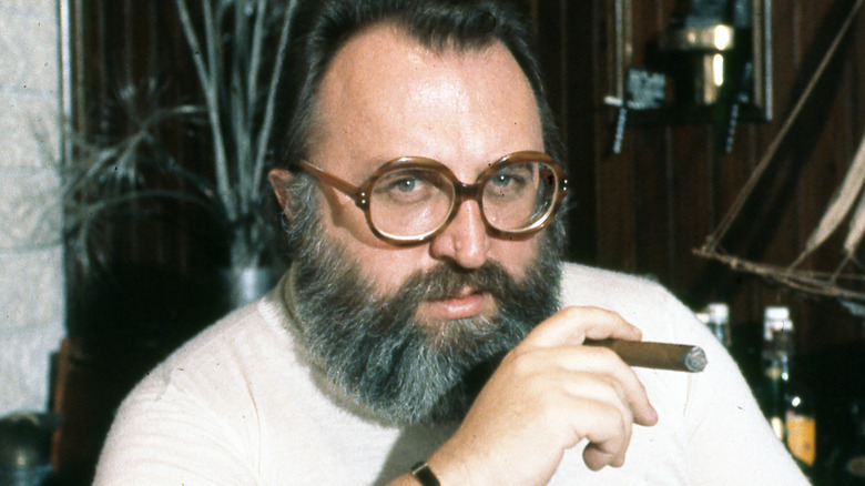 sergio leone sat glasses beard holding cigar