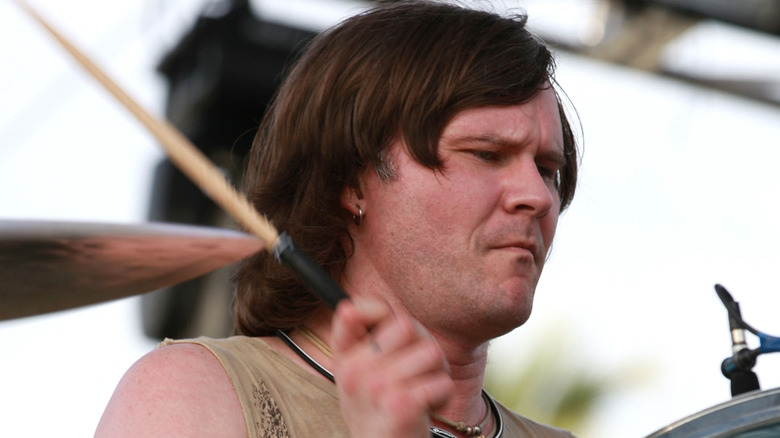 william goldsmith playing drums squinting