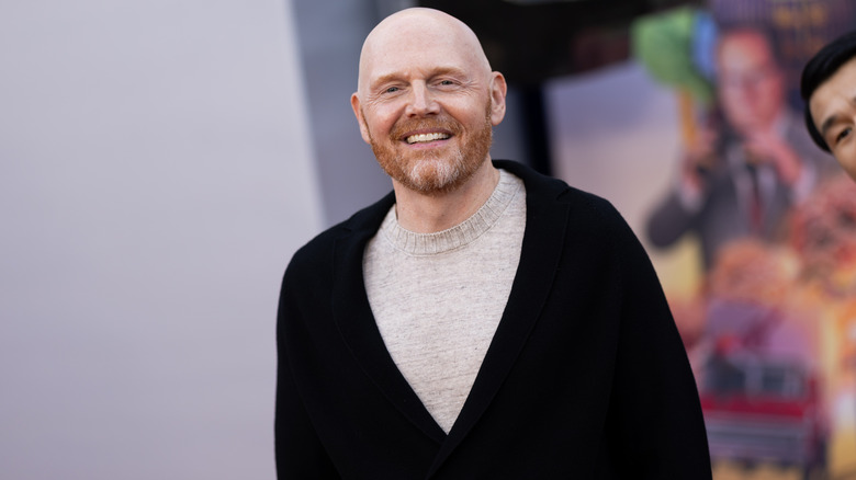 Bill Burr smiling beard black cardigan at event