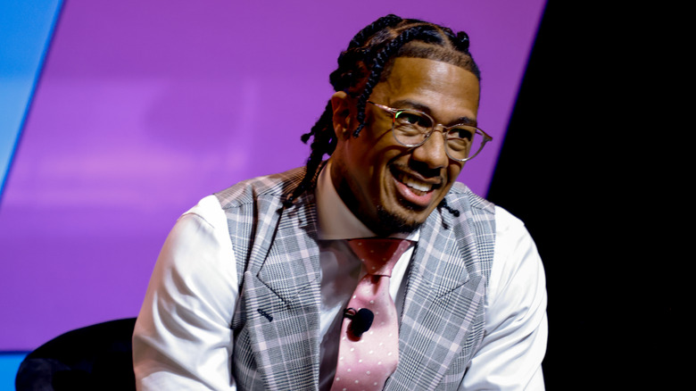 Nick Cannon glasses shirt vest tie smiling