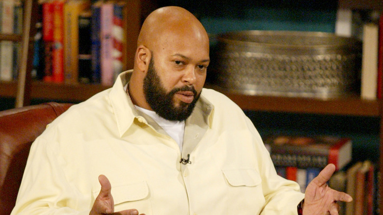 Suge Knight white shirt beard sat talking