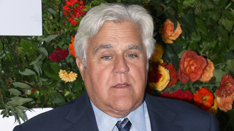 Jay Leno at an event with flowers in background