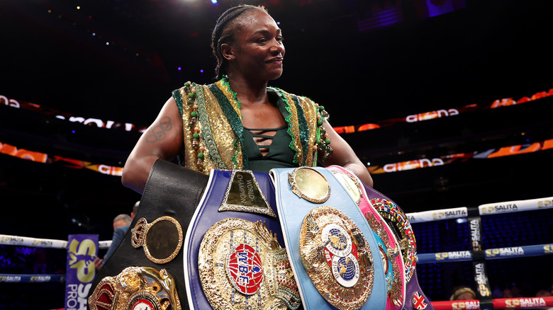 Claressa Shields holding her belts