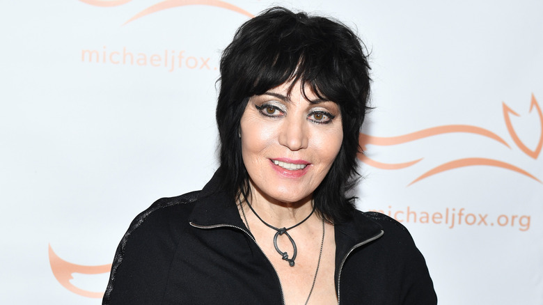 Joan Jett wearing a black top and smiling