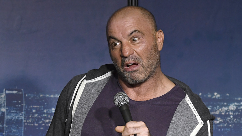 Joe Rogan holding mic pulling face