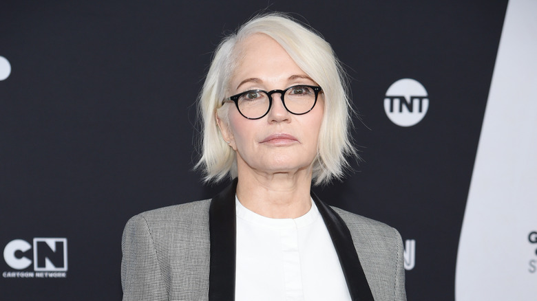 Ellen Barkin wearing glasses and posing for a photo