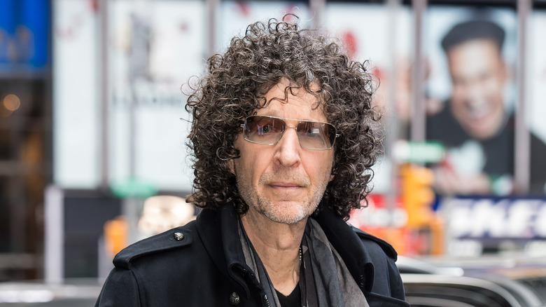 Howard Stern wearing sunglasses and all black, looking ahead