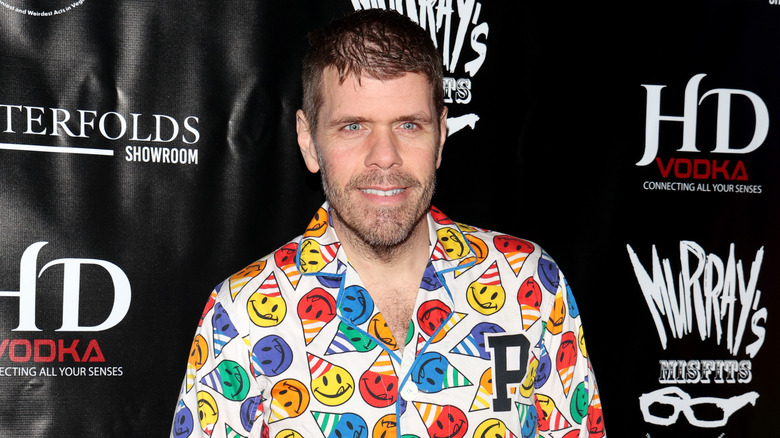 Perez Hilton wearing a colorful shirt and smiling for a photo