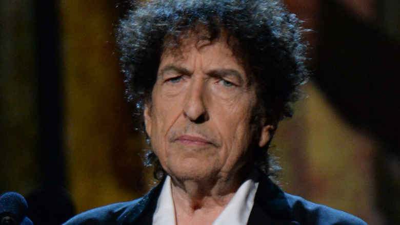 Bob Dylan staring off looking mad curly hair