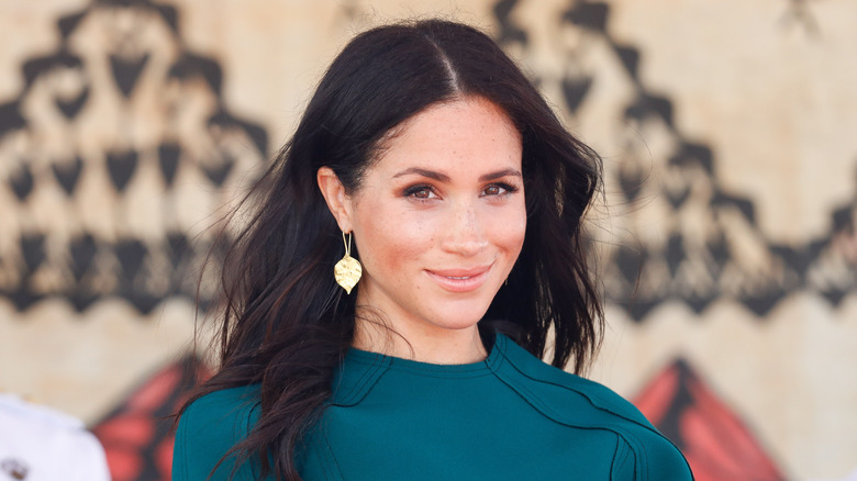 Meghan Markle smiling while looking at the camera