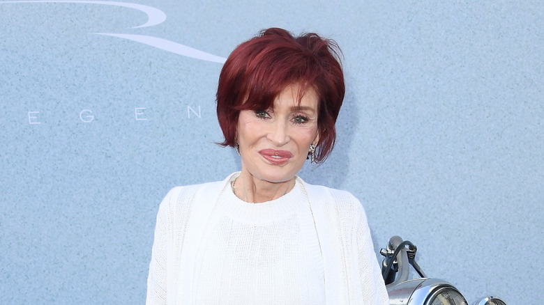 Sharon Osbourne posing in front of a motorcycle while attending 2024 premiere of The Bikeriders