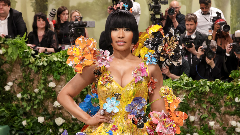 Nicki Minaj wearing a colorful outfit and posing for a photo