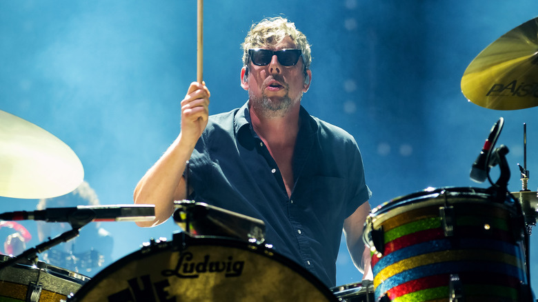 A sunglasses-wearing Patrick Carney playing drums at the O2 Academy Brixton in 2024