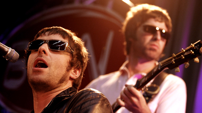 Liam and Noel Gallagher of Oasis performing onstage