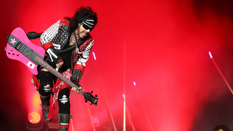 Nikki Sixx on stage with pink bass