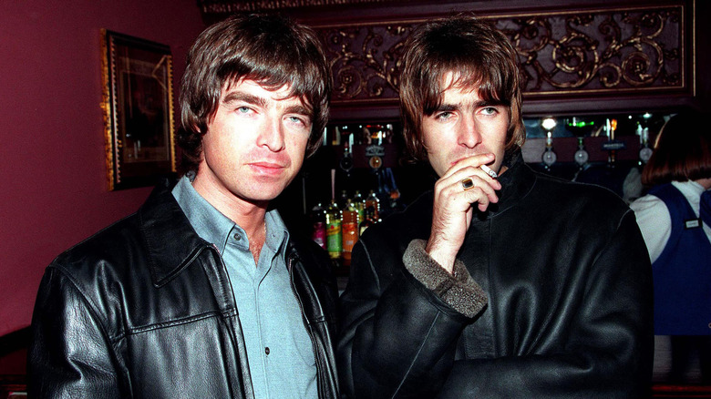 Noel and Liam Gallagher in leather jackets in pub