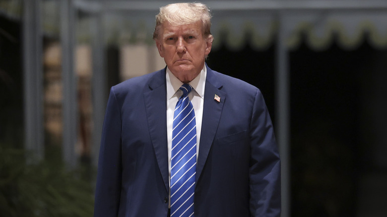 Donald Trump blue suit and tie walking