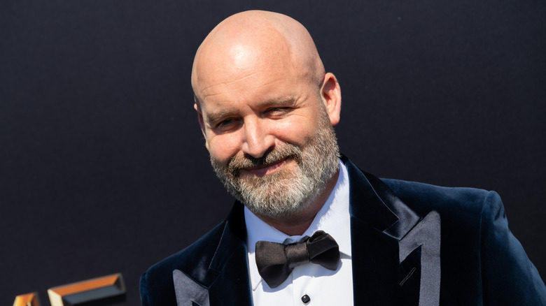 Tom Segura in a suit and tie at an event