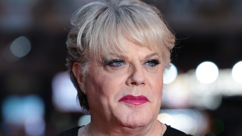 Eddie Izzard looks left