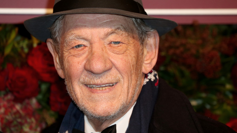 Ian McKellen smiles from under fedora